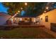 Cozy backyard deck with string lights, stylish seating, and manicured lawn at 5601 Rosslyn Ave, Indianapolis, IN 46220