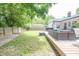 The backyard is spacious with a furnished deck, green grass, and a sturdy fence for outdoor activities and privacy at 5601 Rosslyn Ave, Indianapolis, IN 46220