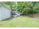 The backyard has a wooden fence, a furnished deck, and green grass for a private and enjoyable outdoor area at 5601 Rosslyn Ave, Indianapolis, IN 46220