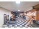 The basement has a finished area with a checkered floor, wood bar, and open layout for versatile use at 5601 Rosslyn Ave, Indianapolis, IN 46220