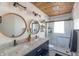 Modern bathroom features double sinks, granite counters, and a glass enclosed shower at 5601 Rosslyn Ave, Indianapolis, IN 46220