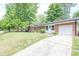 Brick home featuring a well-maintained lawn and a convenient driveway at 5601 Rosslyn Ave, Indianapolis, IN 46220
