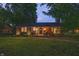 Charming brick home with a well-maintained lawn and cozy front porch seating area at 5601 Rosslyn Ave, Indianapolis, IN 46220
