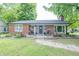 Charming brick home with a well-manicured lawn and inviting front porch at 5601 Rosslyn Ave, Indianapolis, IN 46220