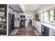 Modern kitchen featuring white cabinets, stainless steel appliances, and hardwood floors at 5601 Rosslyn Ave, Indianapolis, IN 46220