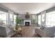 Cozy living room with a fireplace, neutral decor, and lots of natural light at 5601 Rosslyn Ave, Indianapolis, IN 46220