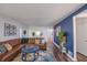 Comfortable living room boasts a blue accent wall, hardwood floors, and natural light at 5601 Rosslyn Ave, Indianapolis, IN 46220