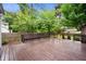 Spacious deck features a built in bench and view of the lush, green backyard at 6020 Gladden Dr, Indianapolis, IN 46220