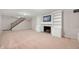 Finished basement featuring carpeting, fireplace with built-in shelves and stairs leading upstairs at 6020 Gladden Dr, Indianapolis, IN 46220