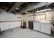 Unfinished basement featuring laundry machines, a utility sink and extra storage cabinets at 6020 Gladden Dr, Indianapolis, IN 46220