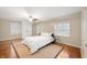 Cozy bedroom with hardwood floors, ceiling fan, and bright natural light at 6020 Gladden Dr, Indianapolis, IN 46220