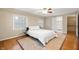 Bedroom showcasing a ceiling fan, two windows, and hardwood floors at 6020 Gladden Dr, Indianapolis, IN 46220