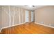 Bedroom featuring hardwood floors, neutral walls and a decorative tree decal on the wall at 6020 Gladden Dr, Indianapolis, IN 46220