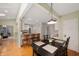 Inviting dining area with a modern pendant light, adjacent to the kitchen with hardwood floors at 6020 Gladden Dr, Indianapolis, IN 46220