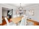 Elegant dining room with a modern chandelier, seating for six, and neutral decor at 6020 Gladden Dr, Indianapolis, IN 46220