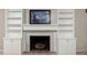 Close up of the fireplace with white mantle, built in shelving and storage at 6020 Gladden Dr, Indianapolis, IN 46220