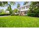 Well-manicured front yard with lush green lawn, mature trees, and attractive landscaping at 6020 Gladden Dr, Indianapolis, IN 46220