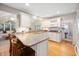 Bright kitchen with granite countertops, white cabinets, stainless steel appliances, and bar seating at 6020 Gladden Dr, Indianapolis, IN 46220