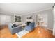 Cozy living room featuring hardwood floors, a fireplace, and built-in bookshelves at 6020 Gladden Dr, Indianapolis, IN 46220