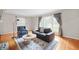 Bright living room filled with natural light, hardwood floors, stylish furniture, and elegant window coverings at 6020 Gladden Dr, Indianapolis, IN 46220
