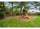 Charming wooden playground with slide and swingset nestled in a private, fenced-in backyard at 6020 Gladden Dr, Indianapolis, IN 46220