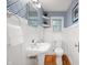 Charming powder room featuring patterned wallpaper and white wainscoting at 6020 Gladden Dr, Indianapolis, IN 46220