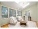 Sitting area with a desk, arm chairs, and plenty of natural light from the many windows at 6020 Gladden Dr, Indianapolis, IN 46220