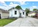 Back exterior of home with grass yard and concrete driveway at 6045 Dewey Ave, Indianapolis, IN 46219