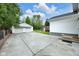 Backyard exterior with paved driveway, 2 car garage, and grass at 6045 Dewey Ave, Indianapolis, IN 46219