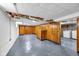Spacious basement area featuring wood paneling, exposed ceiling, and laundry hookups at 6045 Dewey Ave, Indianapolis, IN 46219