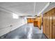 Unfinished basement space with painted block walls, wood paneling, and ample room for storage or recreation at 6045 Dewey Ave, Indianapolis, IN 46219