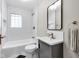Cozy bathroom features a tub with white subway tile surround, modern vanity and updated fixtures at 6045 Dewey Ave, Indianapolis, IN 46219