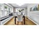 Bright dining room with hardwood floors, large windows, and direct access to the kitchen at 6045 Dewey Ave, Indianapolis, IN 46219
