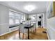 Dining room featuring hardwood floors, decorative lighting, and a breakfast nook at 6045 Dewey Ave, Indianapolis, IN 46219