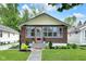 Charming brick bungalow with a well-maintained front yard and a cozy, inviting entrance at 6045 Dewey Ave, Indianapolis, IN 46219