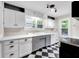 Spacious kitchen features checkered floors, modern appliances, double windows, and plenty of cabinet space at 6045 Dewey Ave, Indianapolis, IN 46219