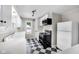 Traditional kitchen featuring checkered flooring, white cabinets, and modern appliances at 6045 Dewey Ave, Indianapolis, IN 46219