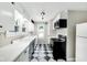 Charming kitchen with black and white checkerboard floors and white cabinets at 6045 Dewey Ave, Indianapolis, IN 46219
