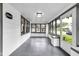 Sunroom featuring bright natural light, gray tile flooring, and neutrally painted walls at 6045 Dewey Ave, Indianapolis, IN 46219