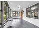 Bright sunroom featuring large windows, gray tile flooring, and neutral color palette at 6045 Dewey Ave, Indianapolis, IN 46219