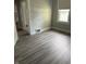Bright bedroom featuring hardwood floors, a window, and light gray walls at 701 N Gladstone Ave, Indianapolis, IN 46201