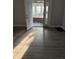 Sunlit entryway showing vinyl floors, neutral paint, and entrance to a porch at 701 N Gladstone Ave, Indianapolis, IN 46201