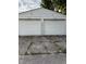 View of a two-car garage with white doors and a cracked concrete driveway at 701 N Gladstone Ave, Indianapolis, IN 46201
