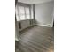Bright living room with neutral paint and new vinyl floors at 701 N Gladstone Ave, Indianapolis, IN 46201
