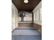 Inviting enclosed front porch features a tree mural and great natural light at 701 N Gladstone Ave, Indianapolis, IN 46201