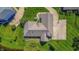 Overhead view of home with basketball court, well-kept lawn, mature landscaping, and pond at 7093 Republic Ln, Indianapolis, IN 46259