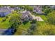 Aerial view of house with basketball court, pond, patio, and mature landscaping at 7093 Republic Ln, Indianapolis, IN 46259