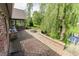 Beautiful brick patio with outdoor kitchen, built-in fire pit, and view of a pond at 7093 Republic Ln, Indianapolis, IN 46259
