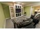 Finished basement boasts custom built-ins for media, and space for seating with an area rug at 7093 Republic Ln, Indianapolis, IN 46259