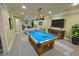 Entertaining basement features a pool table, living area, and ample room for relaxation at 7093 Republic Ln, Indianapolis, IN 46259